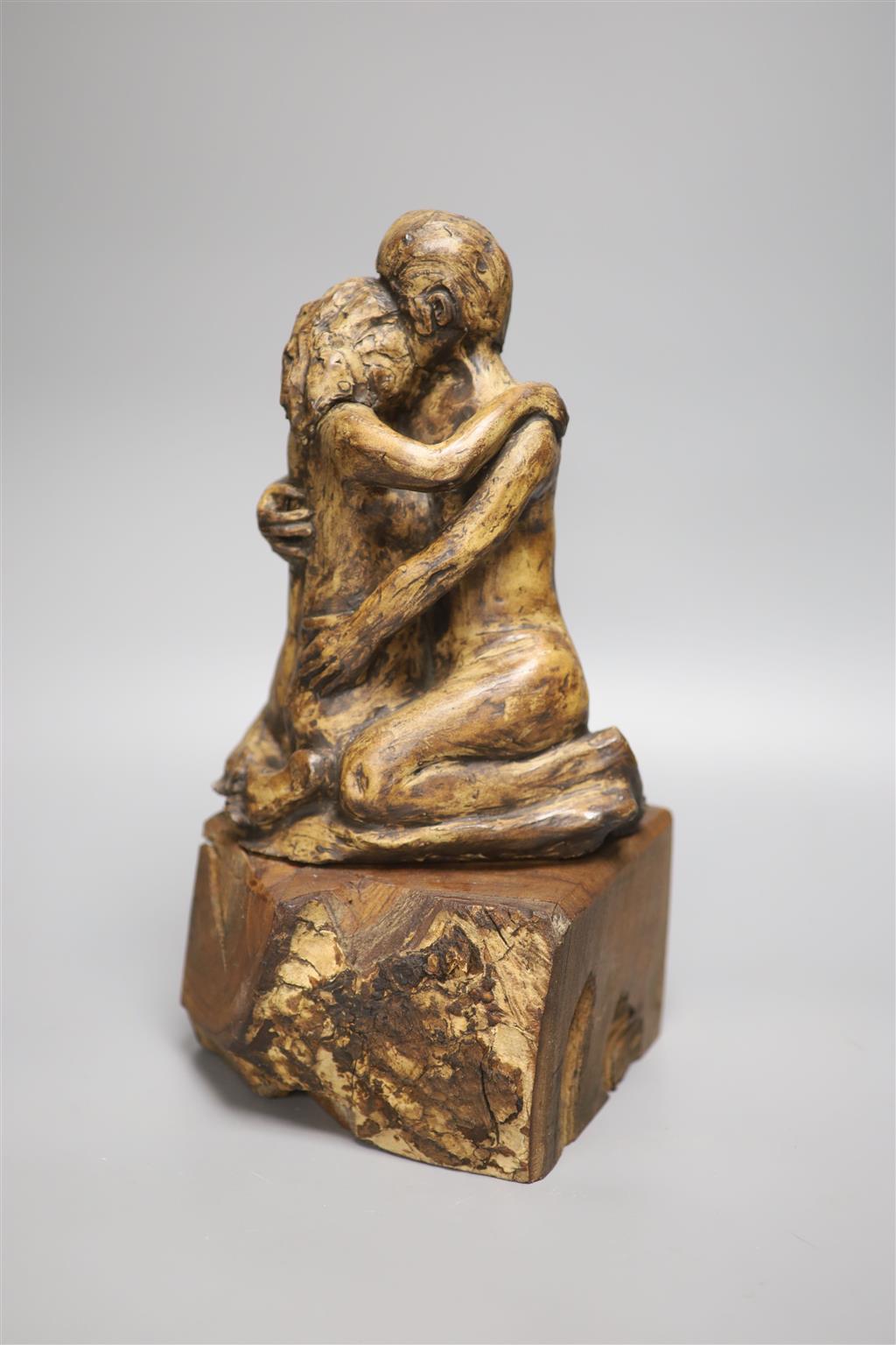 A resin sculpture of lovers on hardwood base, stamped to reverse PHD, height 34cm